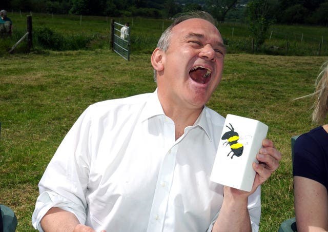 Liberal Democrat leader Sir Ed Davey painting pottery