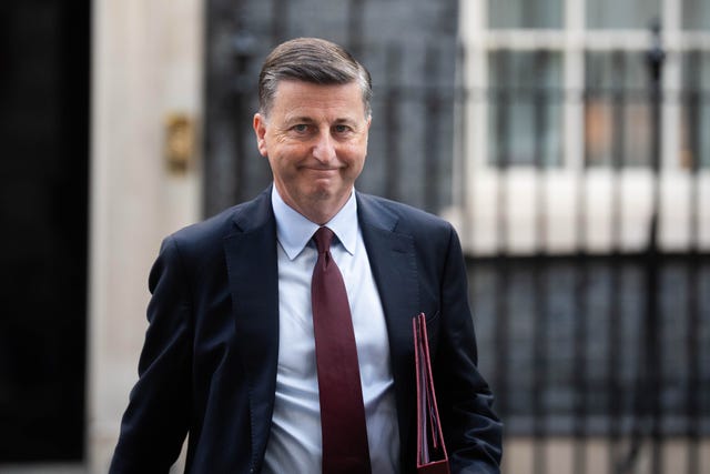 Douglas Alexander smiling while on Downing Street