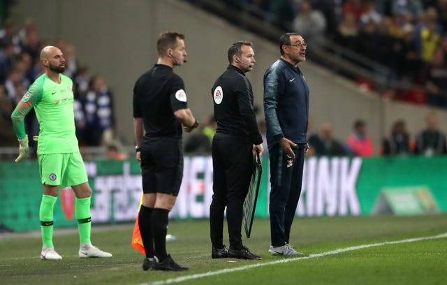 Chelsea manager Maurizio Sarri and Willy Caballero stand on the touchline as goalkeeper refuses to be substituted in extra time during the Carabao Cup final 