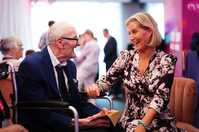 The duchess speaking to 80-year-old Geoffrey Leer during the celebrations