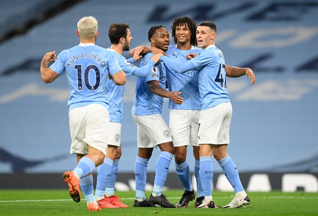 Sergio Aguero, left, joins the celebrations after Raheem Sterling, centre, scored against Arsenal