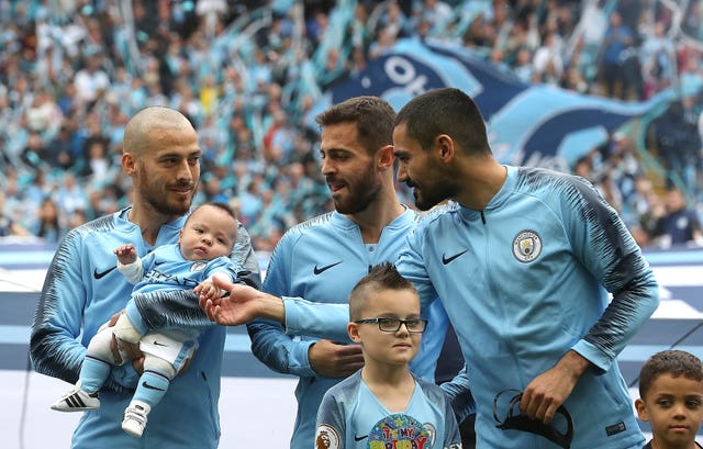 David Silva, left, on the pitch with his baby son Mateo 