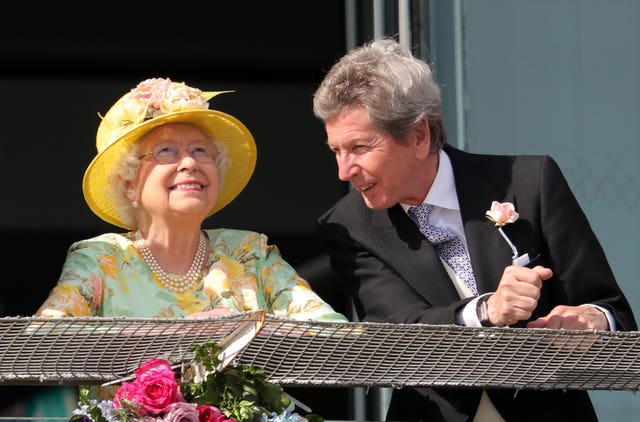 The Queen with her racing manager John Warren - Zalie's grandfather - on Derby Day (Andrew Matthews/PA)