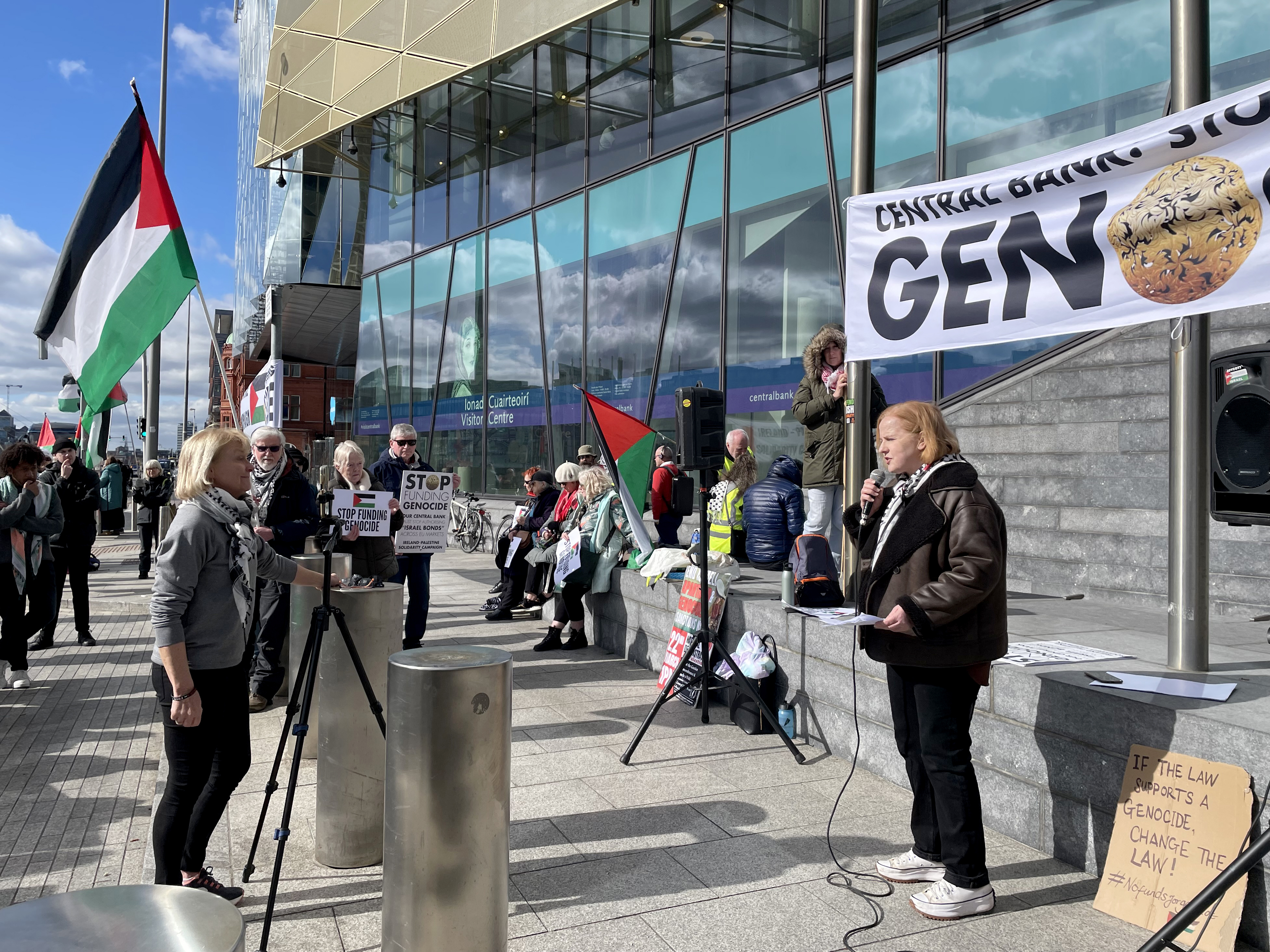 Ruth Coppinger speaking into a microphone during a protest