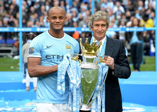 Kompany pictured with former City boss Manuel Pellegrini after winning the 2014 Premier League title