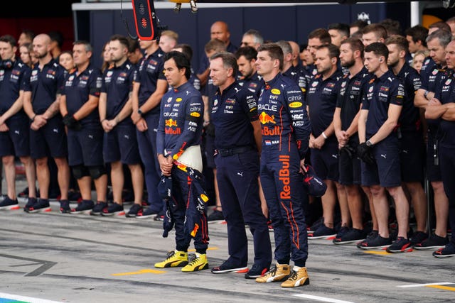 World champion Max Verstappen observes the one-minute silence alongside Red Bull team principal Christian Horner and team-mate Sergio Perez
