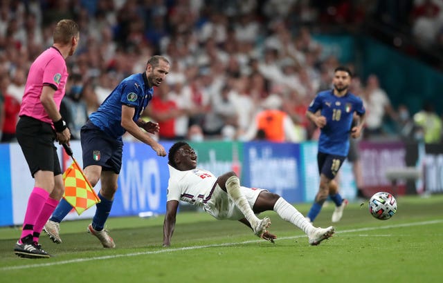 Where do you think you are going? Giorgio Chiellini (left) stops Bukayo Saka in his tracks 