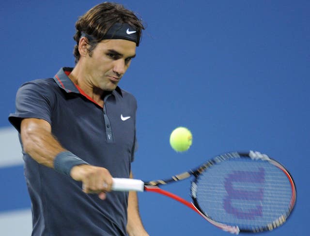 Roger Federer hits a backhand