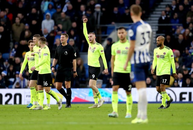 Oliver McBurnie (centre) celebrates his goal 