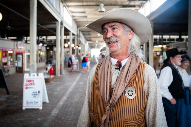 Street performer Pacos Slim posing for a photo in the Fort Worth Stockyards