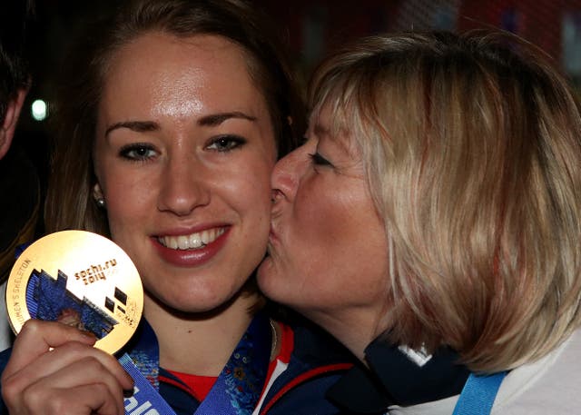Yarnold is kissed by her mother, Judith as she celebrates winning gold 