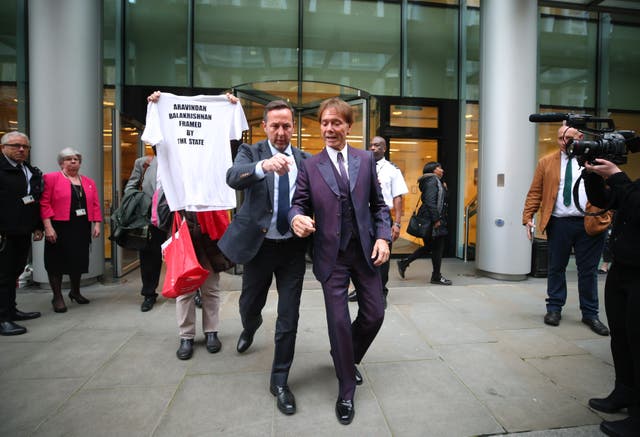 Sir Cliff Richard, right, leaves the Rolls Building in London, where a High Court judge was hearing evidence (Yui Mok/PA)