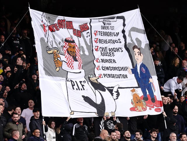 Crystal Palace fans hold up a banner criticising Newcastle's new owners during a Premier League match at Selhurst Park last season