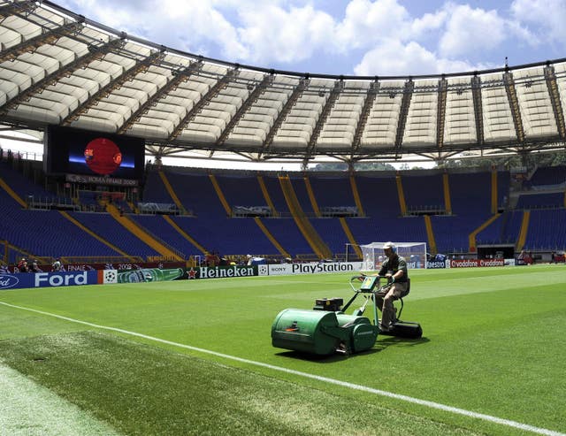 A groundsman cuts the grass at the Olympic Stadium, Rome.