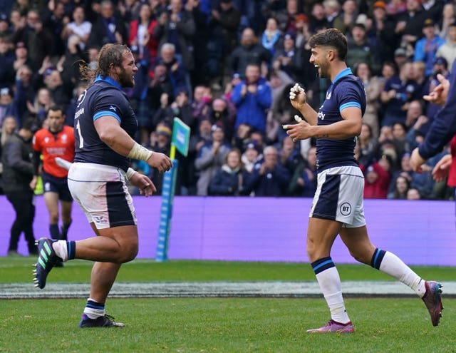Adam Hastings, right, celebrates scoring his try
