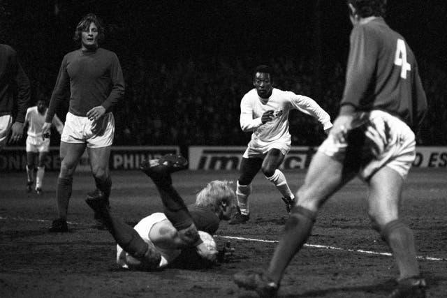 Fulham goalkeeper Peter Mellor dives at the feet  of Pele to smother the ball 