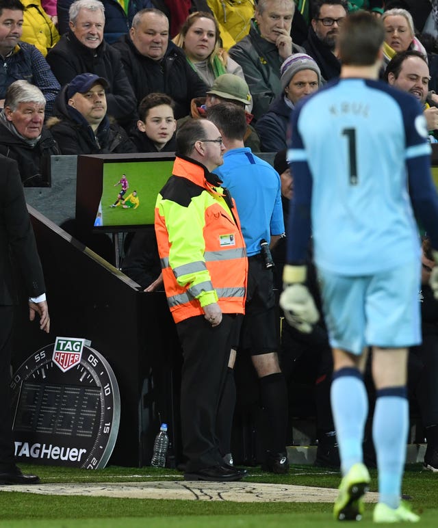 Paul Tierney consulted the pitchside monitor before changing Norwich City's Ben Godfrey's card from a yellow to a red 