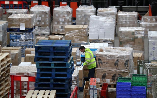 A worker gathers supplies at the NHS National Procurement Warehouse in Larkhall, Scotland