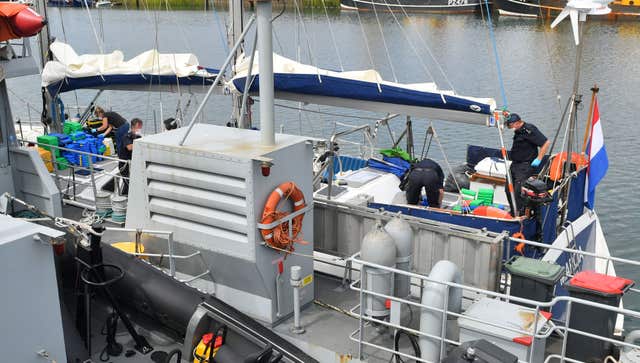 Drugs are unloaded from a boat by officers at Newlyn harbour