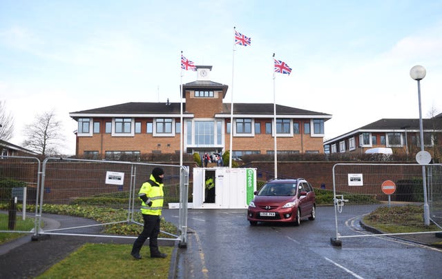 A car leaves Kents Hill Park Training and Conference Centre in Milton Keynes where coronavirus evacuees were released from quarantine