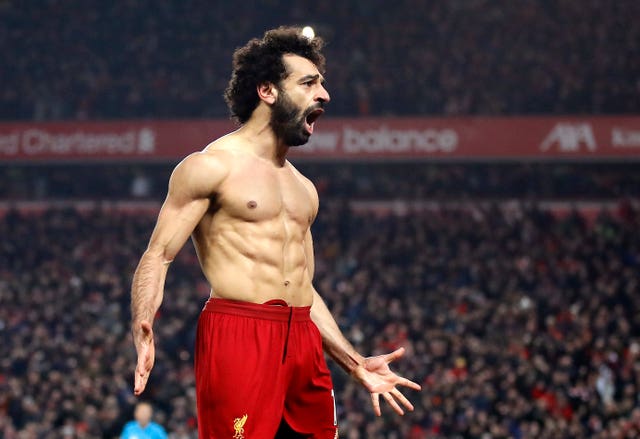 Liverpool forward Mohamed Salah reveals his remarkable physique in front of a euphoric Kop after whipping of his shirt having raced away to seal a 2-0 win over Manchester United in January. Victory over arch rivals United moved Jurgen Klopp's side 16 points clear at the top of the table, prompting chants of 'We're gonna win the league' from Reds fans