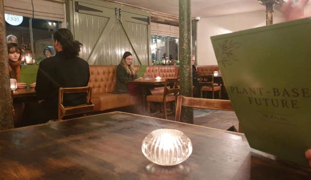 Aactivists from Animal Rebellion holding green menus during a protest in the Newcastle restaurant House of Tides