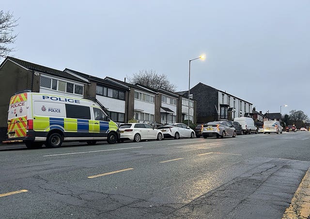 Police near to the scene where a red Seat Leon collided with a Citroen C4 Picasso taxi on Wigan Road in Bolton