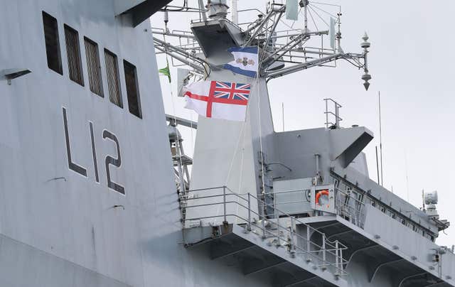 The Ensign is lowered at the decommissioning ceremony for HMS Ocean at HMNB Devonport in Plymouth (Andrew Matthews/PA)