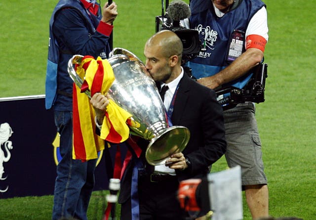 Pep Guardiola lifts the Champions League trophy with Barcelona