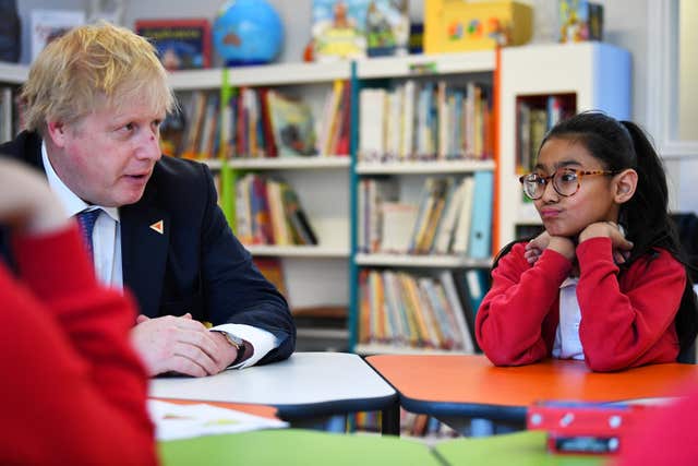 Foreign Secretary Boris Johnson sits with pupils on a visit to St Leonard's Church of England Primary Academy in Hastings (Dylan Martinez/PA)