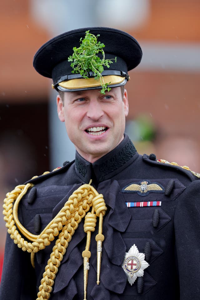 The Prince of Wales with traditional shamrock in his cap, smiles during a visit to the 1st Battalion Irish Guards for the St Patrick’s Day Parade, at Mons Barracks in Aldershot