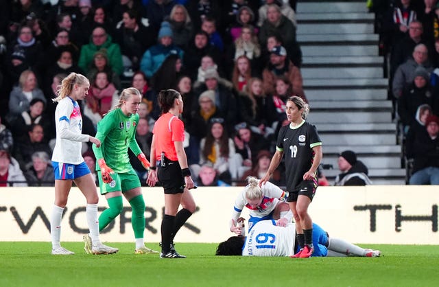 England’s Alex Greenwood comforts injured team-mate Michelle Agyemang