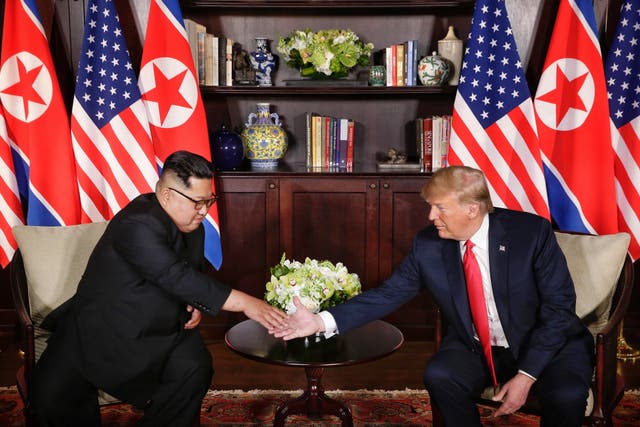 Kim Jong Un shakes hands with Donald Trump