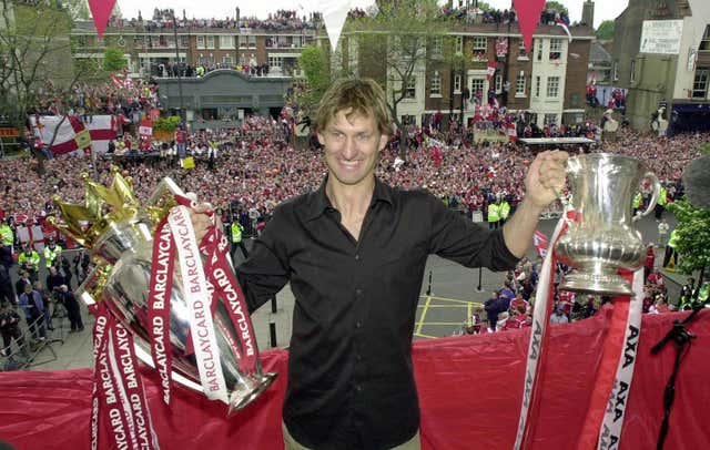 Former Arsenal captain Tony Adams with the Premiership Trophy (left) and FA Cup. (PA)