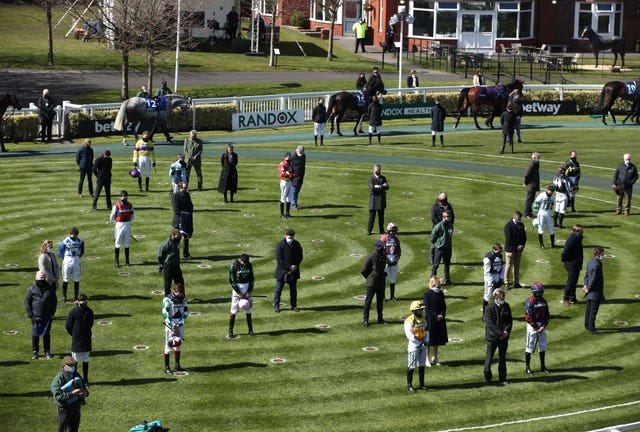 Racegoers and riders at Aintree observe a two-minute silence for the late Prince Philip, Duke of Edinburgh