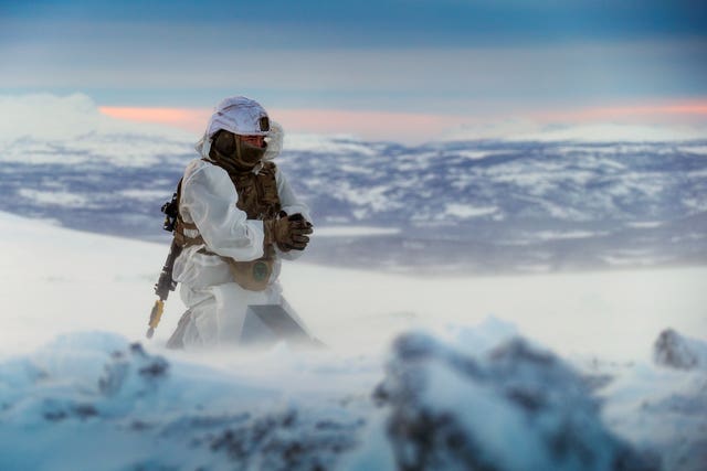 A Royal Marines assault engineer of 45 Commando preparing a charge during ice demolition training in the Arctic Circle, taken by Leading Photographer Stevie Burke