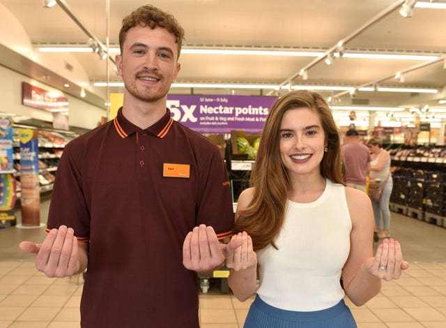 Actress Rachel Shenton, right, demonstrates sign language with Sainsbury's worker Sam Book