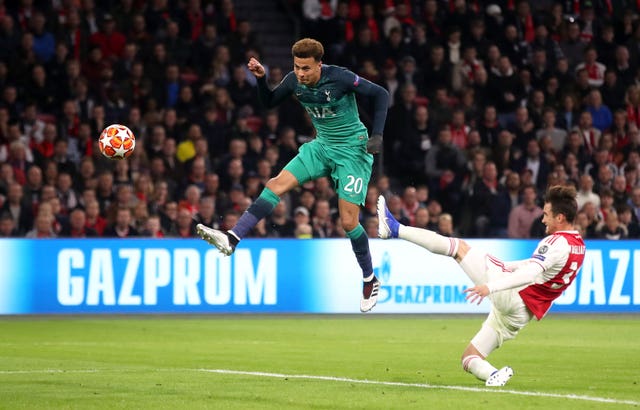 Dele Alli (centre) brings a fine save from Andre Onana