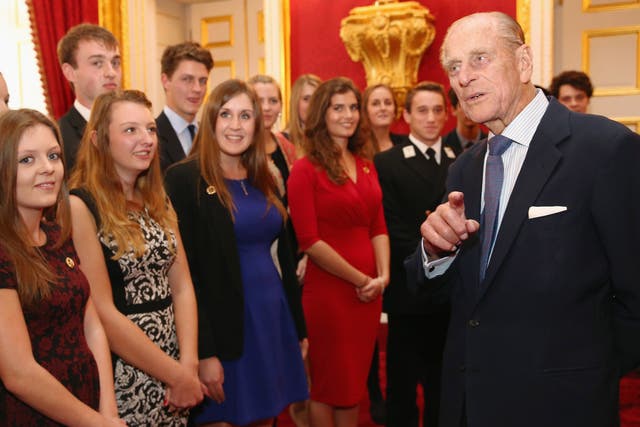 Philip speaks with a group of young people during a reception to celebrate for Duke of Edinburgh Award participants