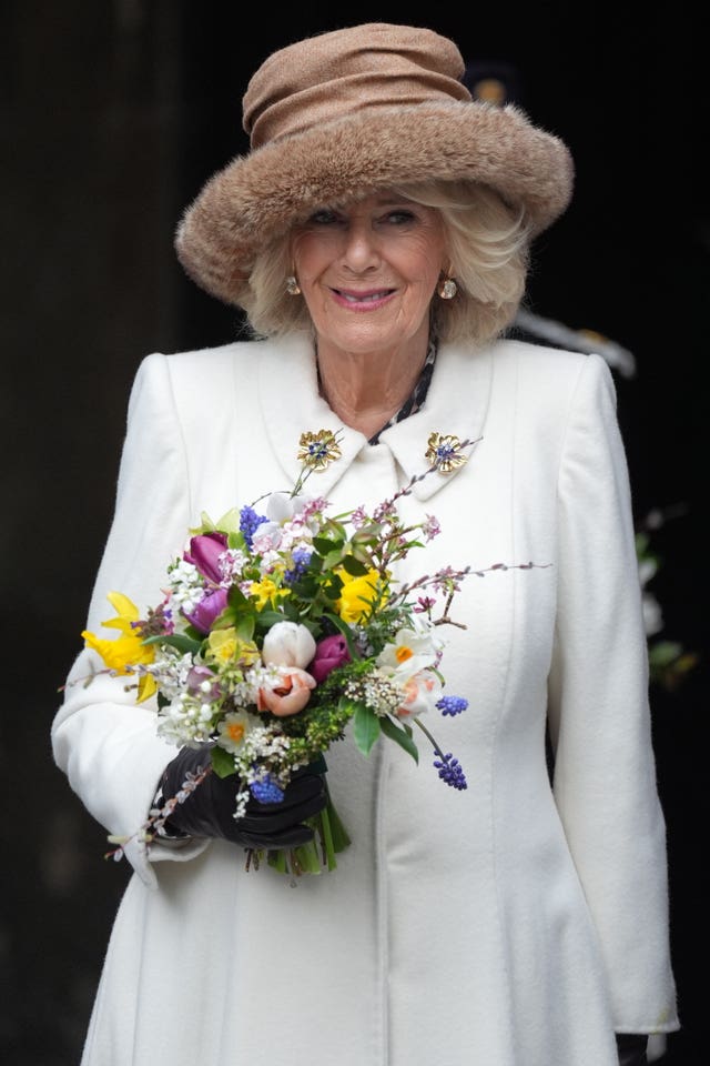 Camilla holding flowers