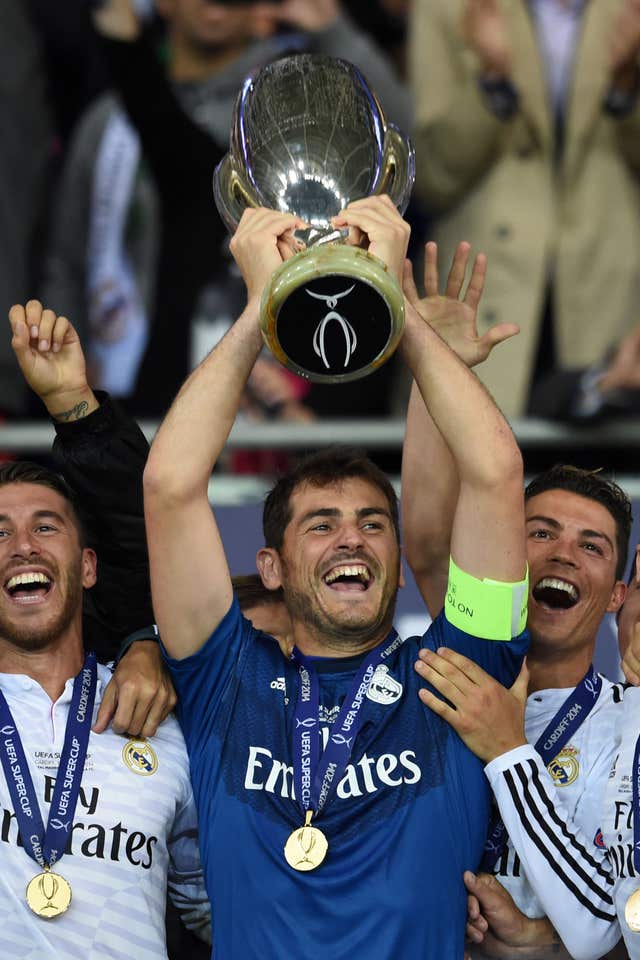 Iker Casillas, centre, lifts the UEFA Super Cup in 2014, flanked by Real Madrid team-mates Cristiano Ronaldo, right, and Sergio Ramos