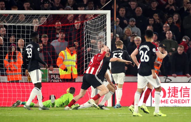 Sheffield United striker Oli McBurnie, centre, scored a stoppage-time equaliser to earn a 3-3 draw with Manchester United