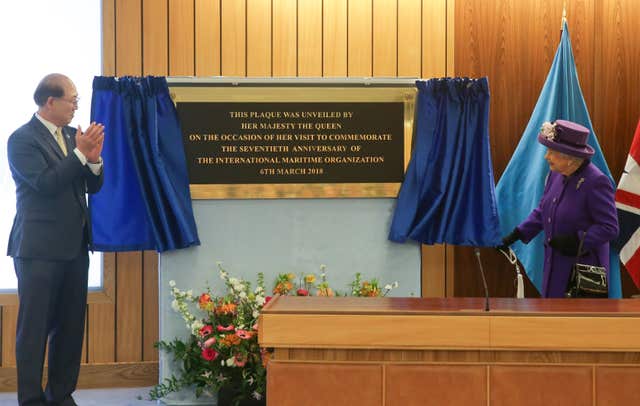 Queen Elizabeth unveils a plaque to record her visit to the International Maritime Organisation which is celebrating 70 years (Daniel Leal-Olivas/PA)