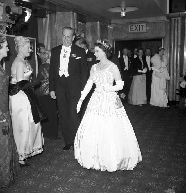The Queen arriving at the world premiere of the film Lawrence of Arabia wearing the gown she would later loan to Beatrice for her wedding day. PA Wire
