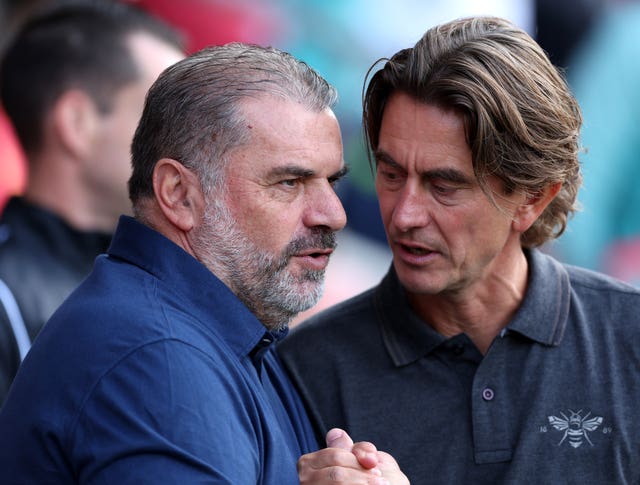 Thomas Frank, right, speaks to Ange Postecoglou at a Premier League match between Brentford and Tottenham
