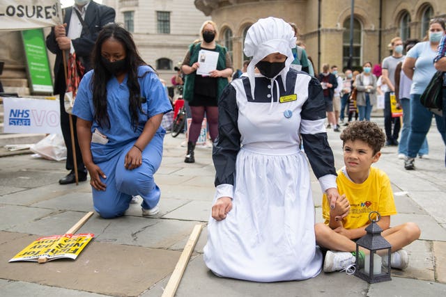 NHS staff and supporters observed a two-minute silence in memory of health workers killed by Covid-19 before the march in central London