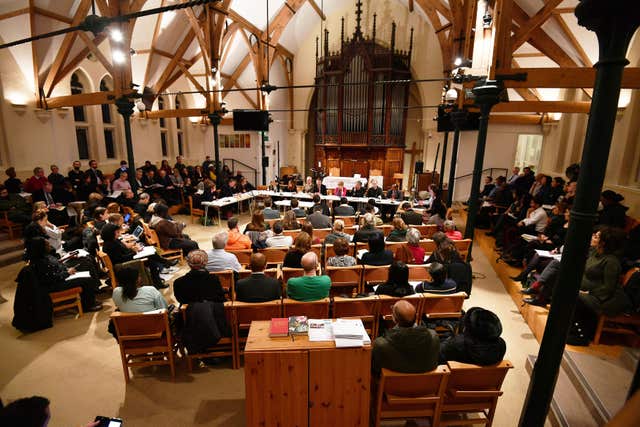 People attend the Grenfell Tower Recovery Scrutiny Committee meeting at the Notting Hill Methodist Church, in north west London. (John Stillwell/PA)