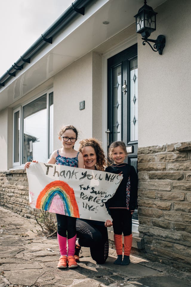 A family with an NHS poster