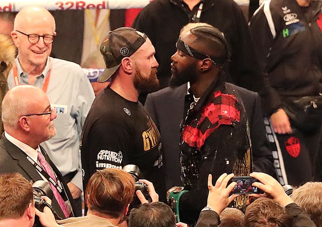 Joshua believes a showdown between Tyson Fury, left, and Deontay Wilder, right, is good for boxing (Niall Carson/PA)