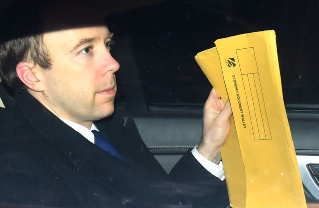 Health Secretary Matt Hancock appears to take his work with him to the Conservative Party Black & White Ball (Dominic Lipinski/PA)